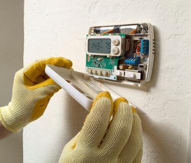 smart thermostat meter reading, technician placing cover