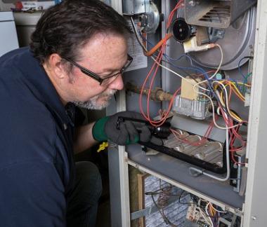 Crandall Heating and Air HVAC Technician servicing HVAC unit