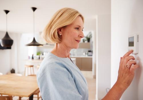 woman setting temperature on smart Hvac DEVICES