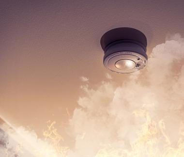 fire alarm smoke detector on ceiling detecting house fire
